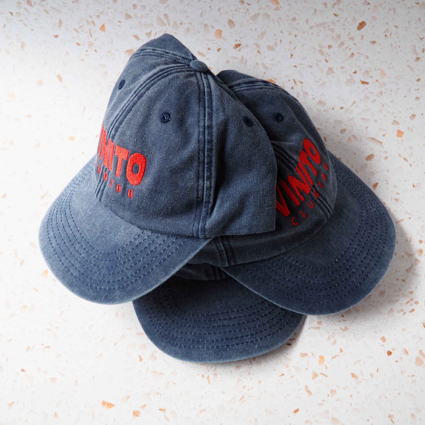 Blue Vinito denim cap with red embroidery text.