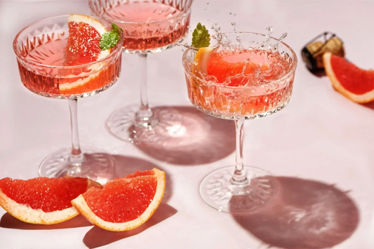 Glasses of canned rosé wine with fresh grapefruit and mint, featuring the best canned rosé wine recommendations for 2025