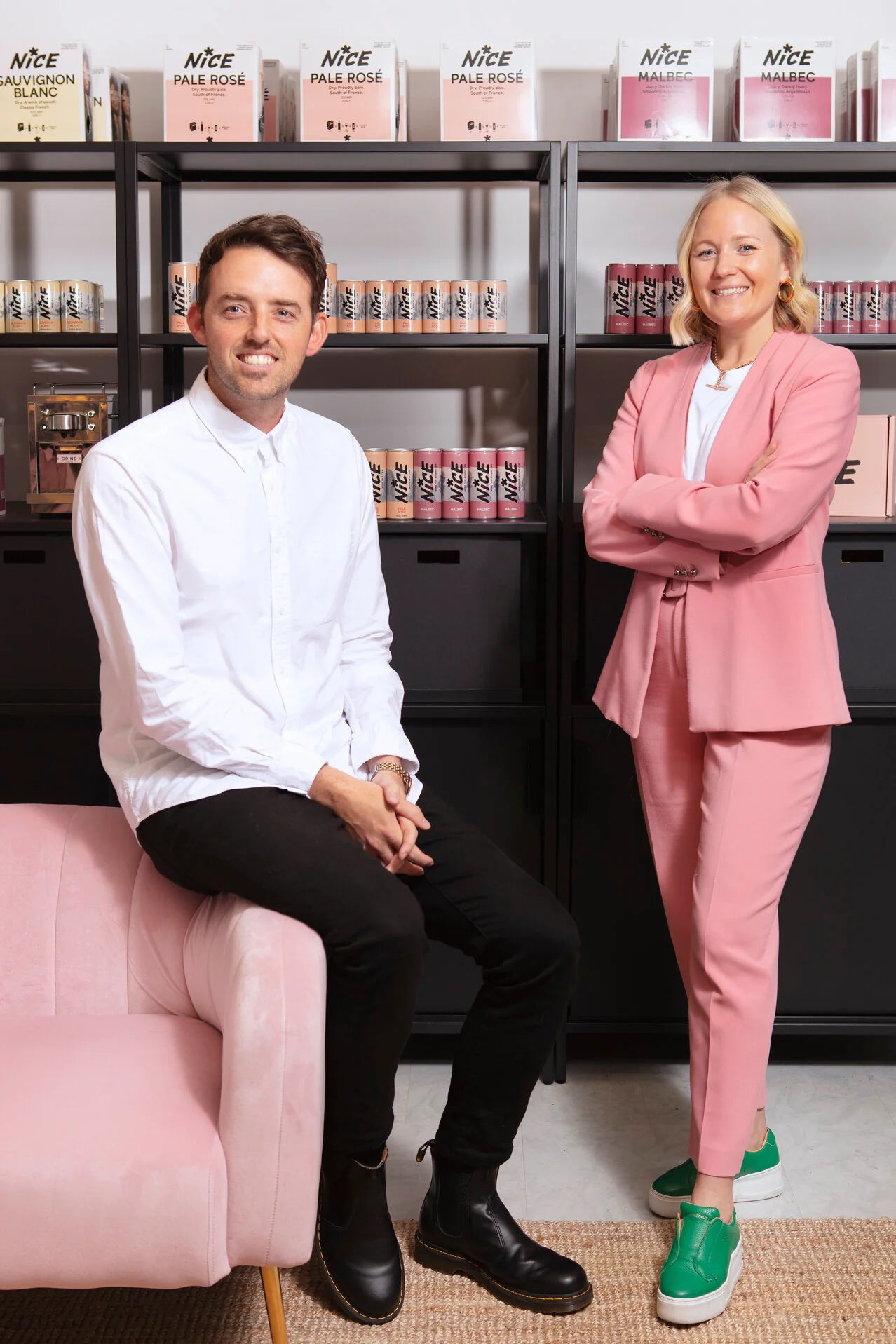 Nice canned wine founders Lucy Busk and Jeremy May posing with their products, representing the UK’s fastest-growing canned wine brand.