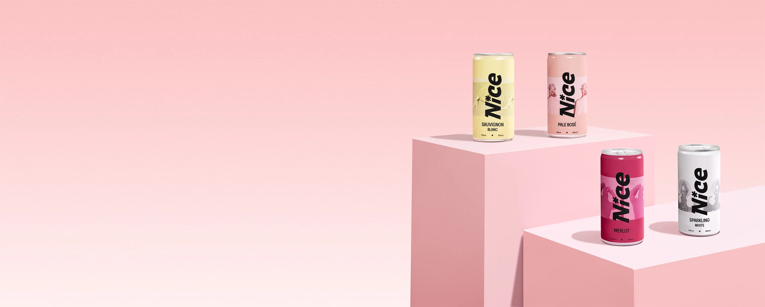 Nice canned wine collection featuring Sauvignon Blanc, Pale Rosé, Merlot, and Sparkling White displayed on a pastel pink background.