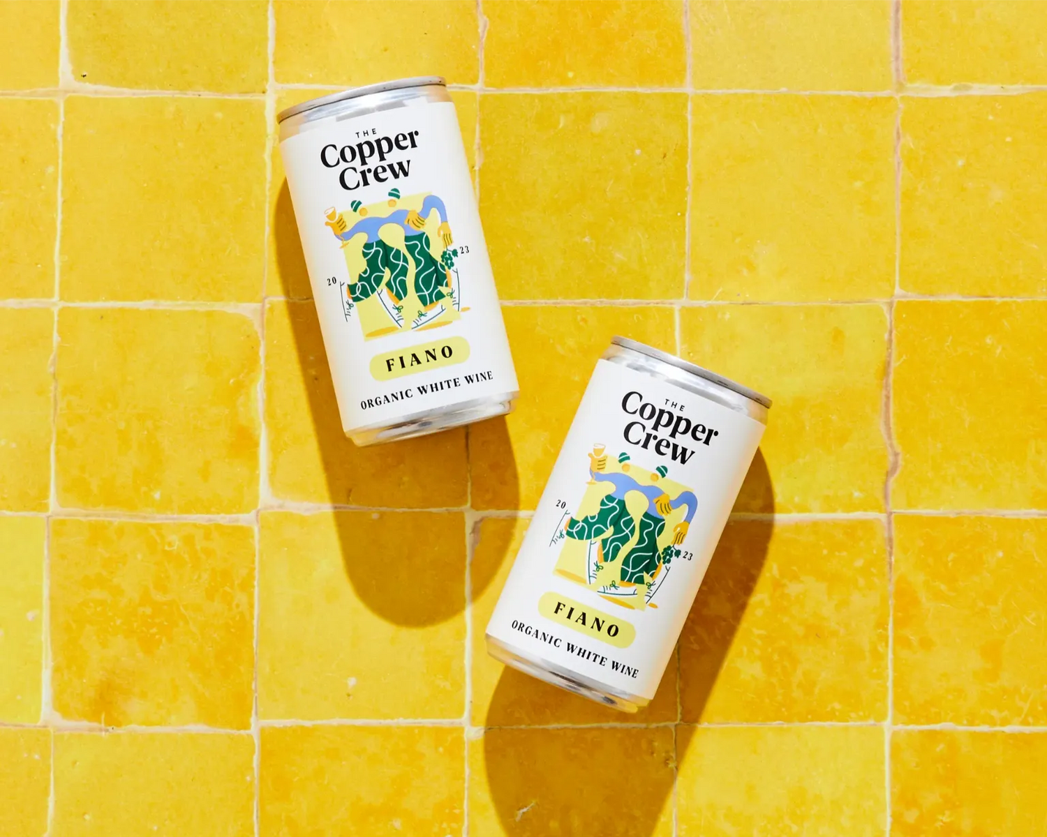 The Copper Crew Organic Fiano canned white wine – bright and tropical Italian wine on a yellow background