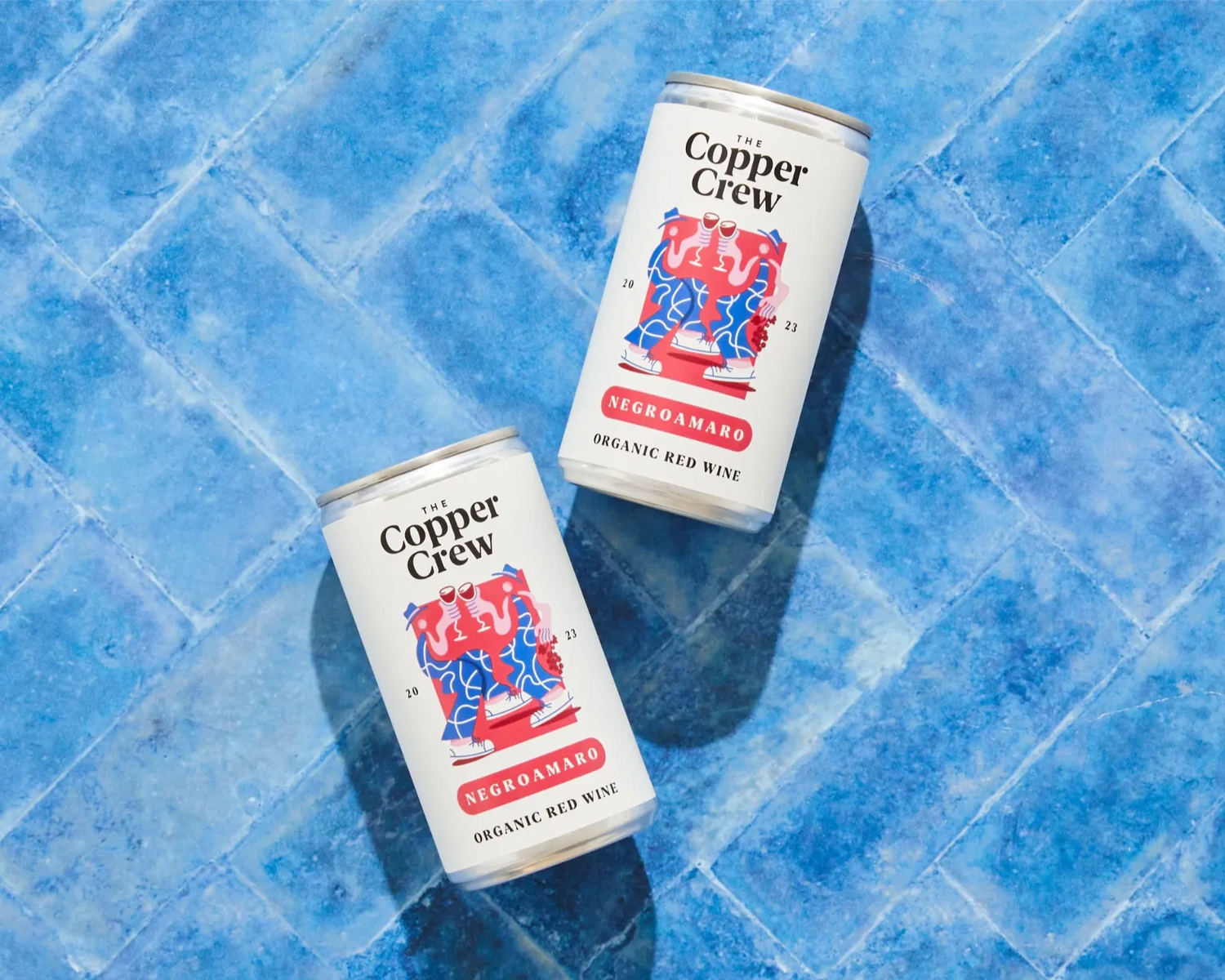 The Copper Crew Organic Negroamaro canned red wine – rich and velvety Italian wine on a blue background