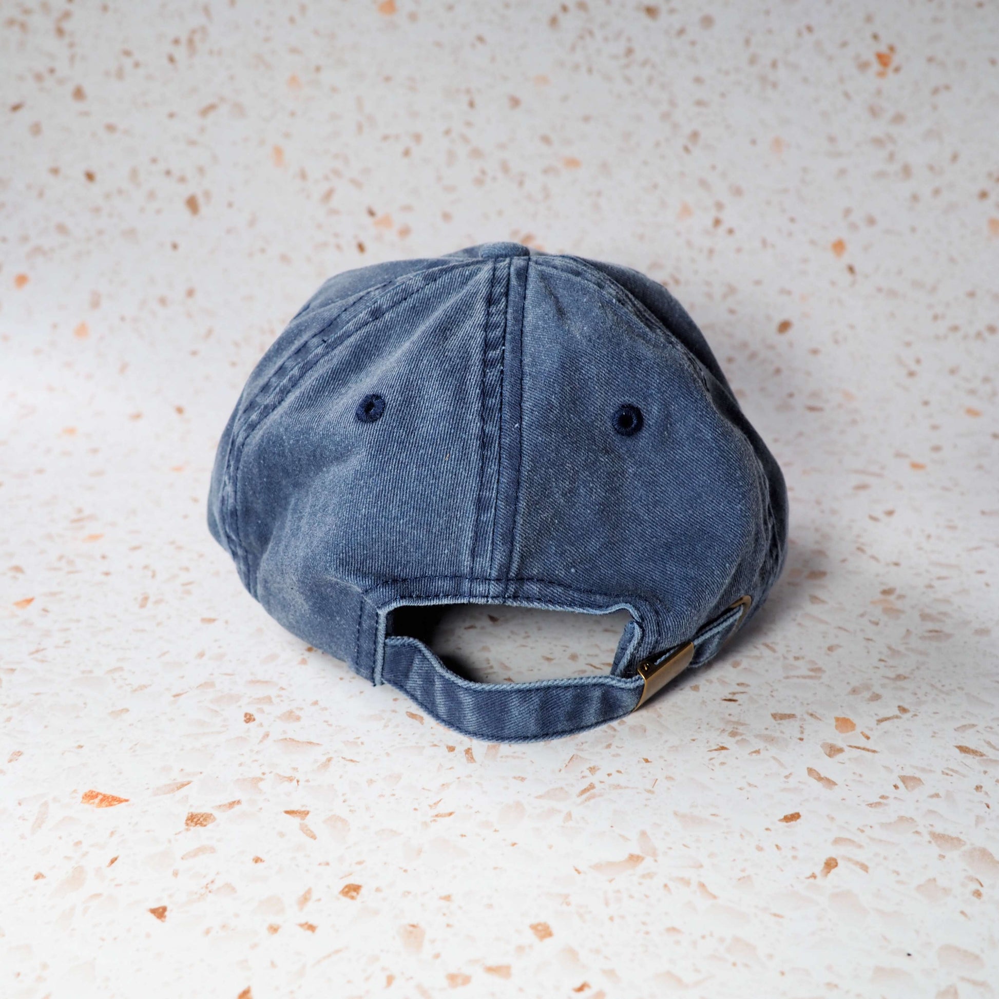 Blue Vinito denim cap with red embroidery text.