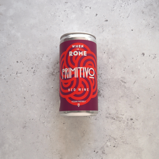 187ml can of When in Rome Primitivo red wine from Puglia, Italy - rich with cherries, prunes, wild fruit, and subtle chocolate notes.